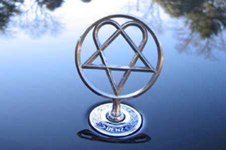 off the custom heartagram hood ornament we made for his Mercedes